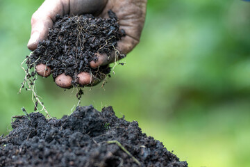 farmer holding soil looking at soil carbon in the america
