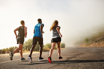 Group, fitness and sport with running in outdoor by training, exercise and practice for marathon competition of cardio health. People, athlete and workout as runner together for performance goal