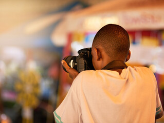 Camera, photography and man in city on vacation, adventure or weekend trip with memory. Travel, tourism and back of male photographer with dslr equipment in urban town for holiday in Florida.