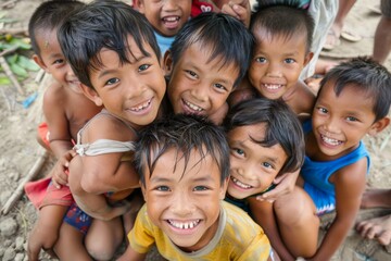 Group of happy kids smiling and looking at the camera on the beach