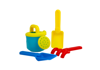 Children's toys for playing in the sand. Children's scoop, watering can and rake for sandbox without background. For text