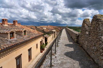 Panoramic view of the medieval walls of the village of book of Uruena with green fields in spring....