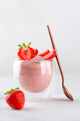 Whipped tofu and strawberry mousse dessert in a glass. Vegan food. Vertical orientation.