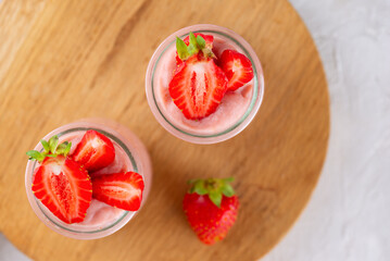 Tofu soy strawberry dessert on a wooden board. Vegan homemade. Lactose and sugar free. Top view.