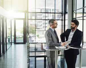 Meeting, tablet and business men in office with discussion for feedback, report review or project...