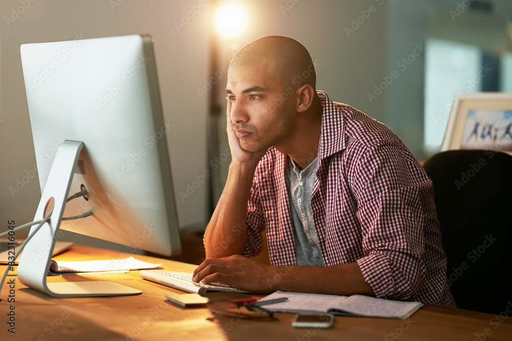 Poster Creative, man and tired with computer in office at night for research, thinking and thoughts for ideas of web design project. Male designer, late and fatigue for overtime on website development task.