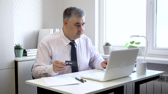 A businessman in the office ecstatically shouts while looking at the computer screen. Ideal for content on making right decisions, successful investments, and lucrative contracts.
