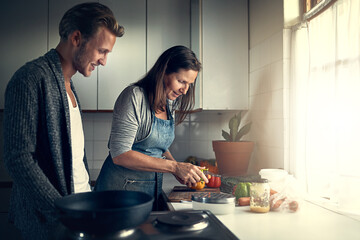 Mature, mother and son with cooking in home for bonding, support or helping with vegetables for...