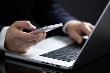 Close-up of a person's hand using a mobile phone for online shopping.