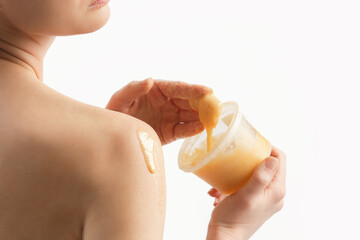 Beauty skin care. Young woman using fruits scrub on her body.	