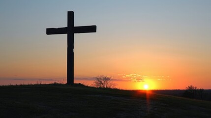 Isolated cross silhouetted against a stunning sunset sky creating a peaceful and serene scene