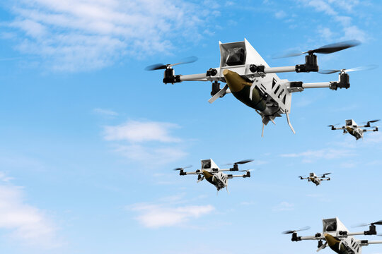 Military kamikaze drones with aerial bombs fly in front of blue sky. War of drones. Unmanned aerial vehicle.