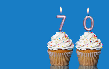 Birthday Cupcakes With Candles Lit Forming The Number 70