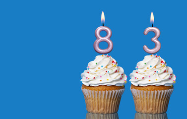 Birthday Cupcakes With Candles Lit Forming The Number 83