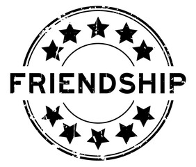 Grunge black friendship word with star icon round rubber seal stamp on white background