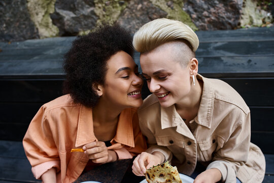 A diverse couple of lesbians sharing a meal in a cozy cafe.
