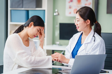 Asian female doctor specializing in psychiatry online consultations from desk, psychotherapy,...