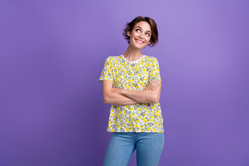 Portrait of pretty young woman look empty space wear t-shirt isolated on purple color background