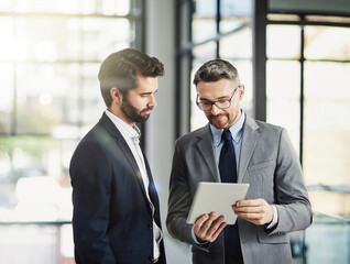 Meeting, discussion and businessmen with tablet for digital report, project proposal or feedback in office. Lens flare, corporate consultant and employees for conversation, collaboration or teamwork