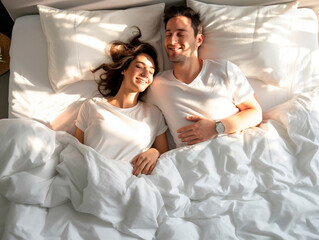 Young smiling couple sleeping in white bed, morning light