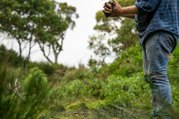 farmer holding soil looking at soil carbon in the america