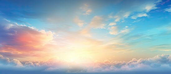 Obraz premium The vibrant sky background is filled with drifting clouds carried by the wind while the sun s rays paint the blue canvas This scene evokes the idea of an overcast sky with beautiful sunrises and suns