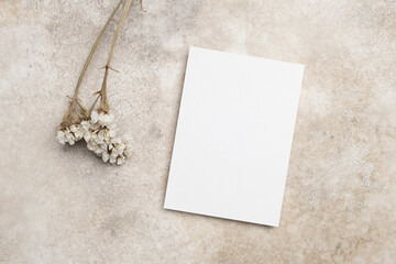 Blank invitation or greeting card mockup with dry botanical decor