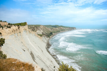 Coastal cliffs sheer to sea at Cape Kidnappers in Hawkes Bay New Zealand.