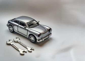 metal miniature car with repair tools on white background