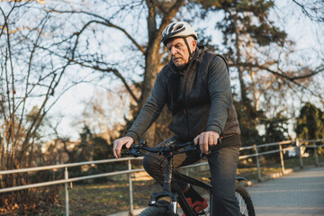 Old Man Cycling in Park