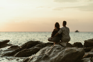 Couple Enjoying Sunset On The Beach