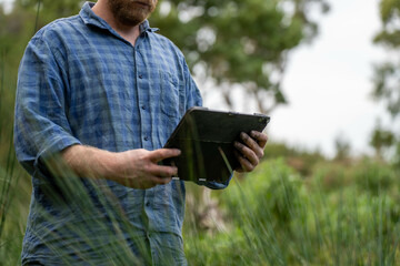 farmer holding soil taking a soil sample for a soil test in a field. Testing carbon sequestration...