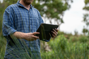 agronomist on a farm practicing agronomy holding soil, doing soil tests in her home laboratory....