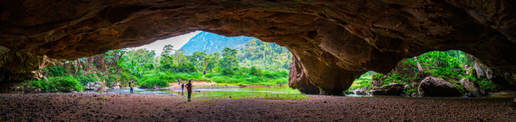Entrance to Hang En Cave, the first cave and camp site of Son Doong trek in Vietnam. The cave is in...
