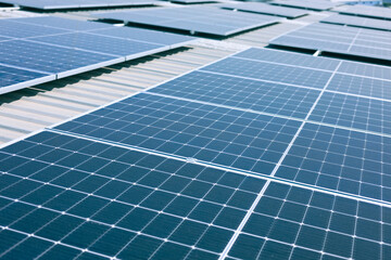 Photovoltaic solar panels mounted on factory rooftop for producing clean ecological...