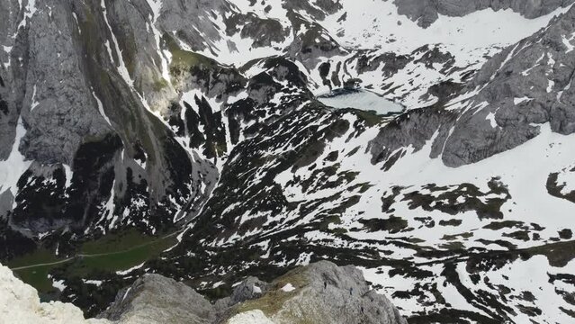 Aerial drone view of snow covered Alps and icy frozen lake in Ehrwald, Austria