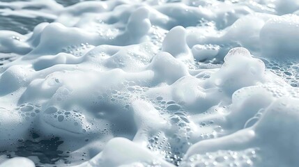 Obraz premium The photo shows the surface of the sea covered with white foam.