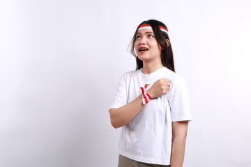 Beautiful Asian woman giving salute celebrate Indonesian independence day on August 17 isolated over white background