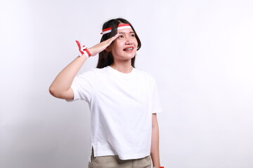 Beautiful Asian woman giving salute celebrate Indonesian independence day on August 17 isolated...