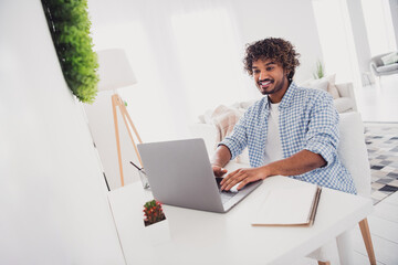 Photo of funky positive man wear checkered shirt chatting modern gadget indoors house apartment room