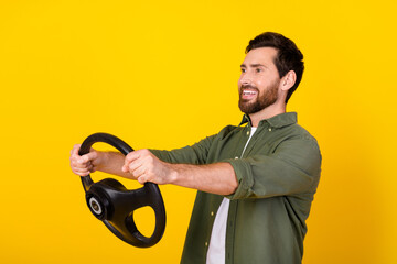 Photo of nice young man hands hold wheel wear shirt isolated on yellow color background
