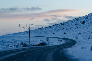 Winding road through snowy hills