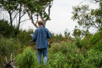 farmer holding soil on her hands on a farm looking after the health of the earth in spring in...