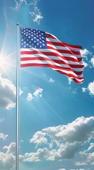 Bright American flag waving in the wind against a clear blue sky with sunlight and white clouds, symbolizing freedom and patriotism.