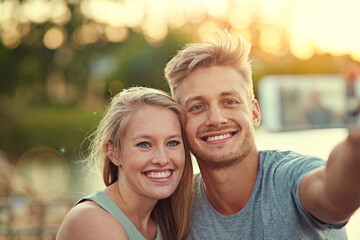 Fototapeta premium Couple, people and happy outdoor with selfie for love, bonding and support with care and fun in California. Relationship, vacation and smile for summer holiday, trip and adventure on joy as soulmate