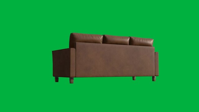 A brown couch with a yellow blanket on it. The couch is on a green background. The couch is a comfortable place to sit and relax
