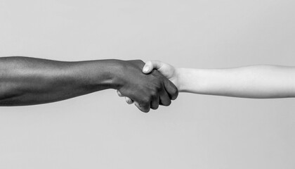 Black and white human hands. African and caucasian hands. Giving a helping hand to another. Woman and african woman hand. Black and white