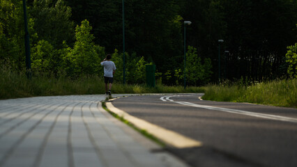 A man is doing physical education walking along a bike path