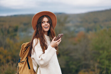 Mountain Woman: A Smiling Adventurous Tourist Captures a Selfie in the Stunning Landscape with Her...