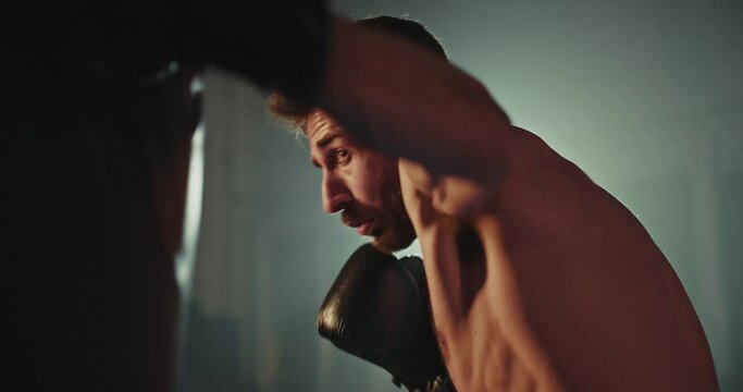 Shirtless Man Holding Black Boxing Glove
